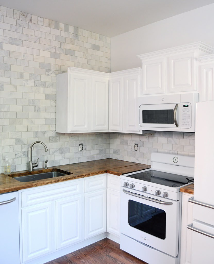 Corner Shot of White-Stained Cabinets and Treated Wood Countertops