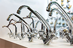 kitchen faucets on shelf closeup plumbing shop