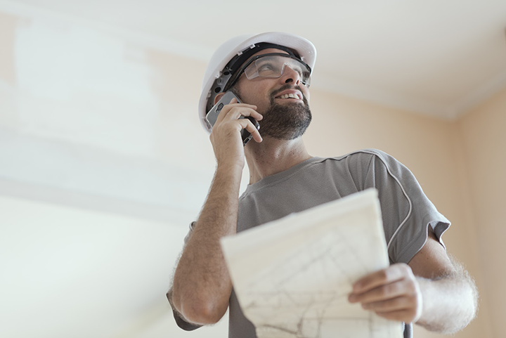 Smiling Architect Having a Phone Call
