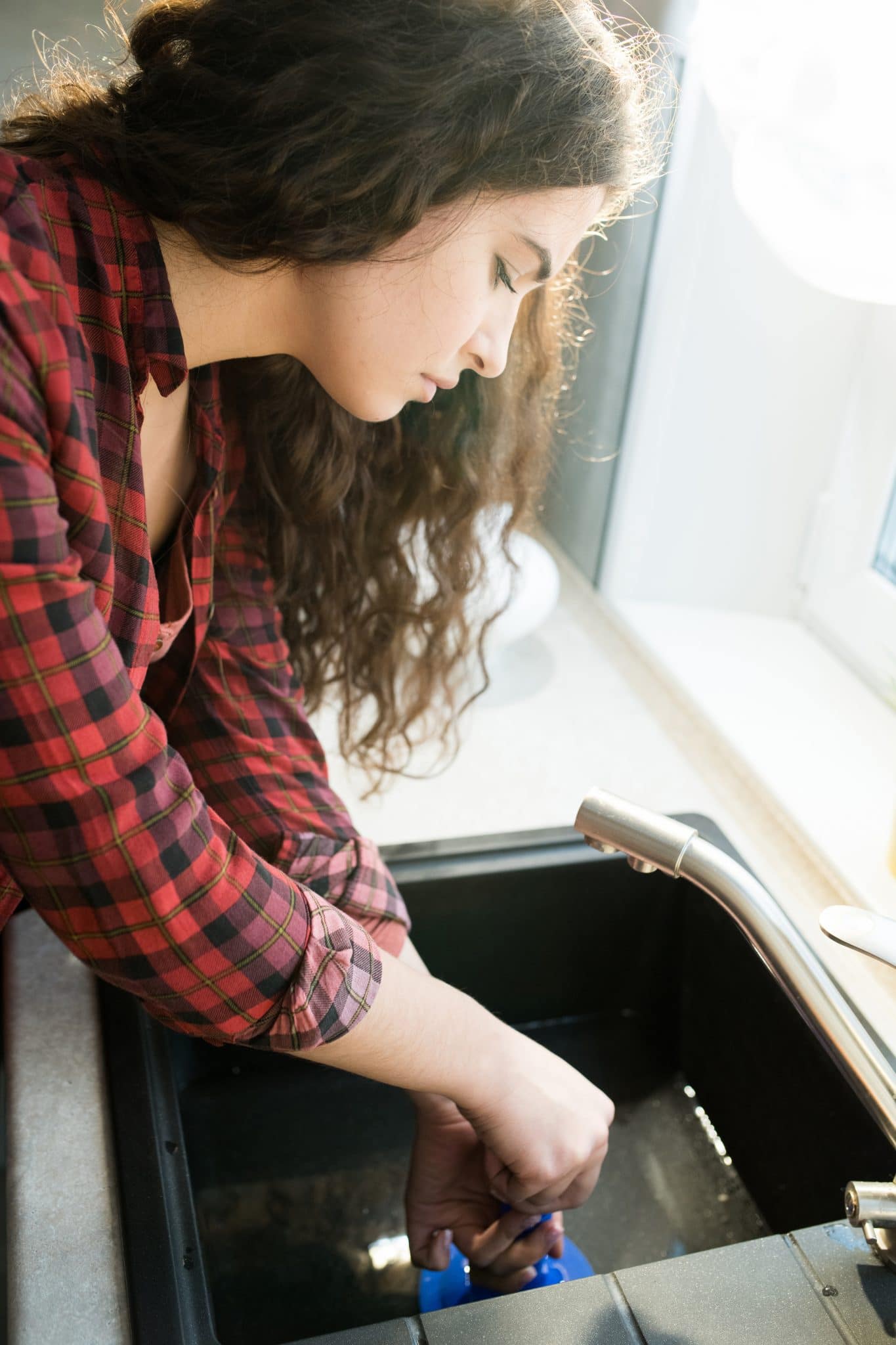 Woman Celaring Clogged Drain